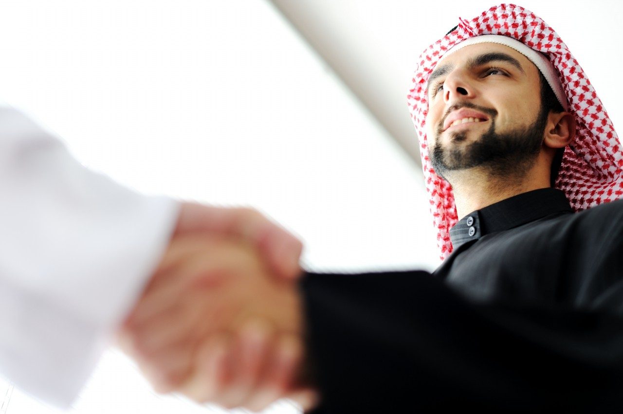 Successful-Arab-business-people-shaking-hands-over-a-deal